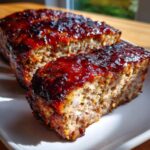 Close-up of a slice of Bbq Meatloaf Cupcakes, glazed with a rich, glossy sauce.