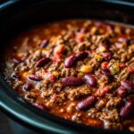 Close-up of a rich and hearty bowl of Best Instant Pot Chili, featuring ground beef, red kidney beans, and tomatoes.