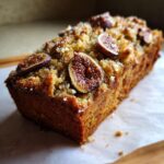 Close-up of a delicious Fig Almond Tea Cake topped with sliced fresh figs and a crumb topping.