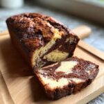 A close-up of a sliced Marble Loaf Cake showing the beautiful chocolate and vanilla swirls.
