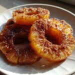Three caramelized pineapple rings coated in brown sugar, ready to eat for Juicy Pineapple Heaven.