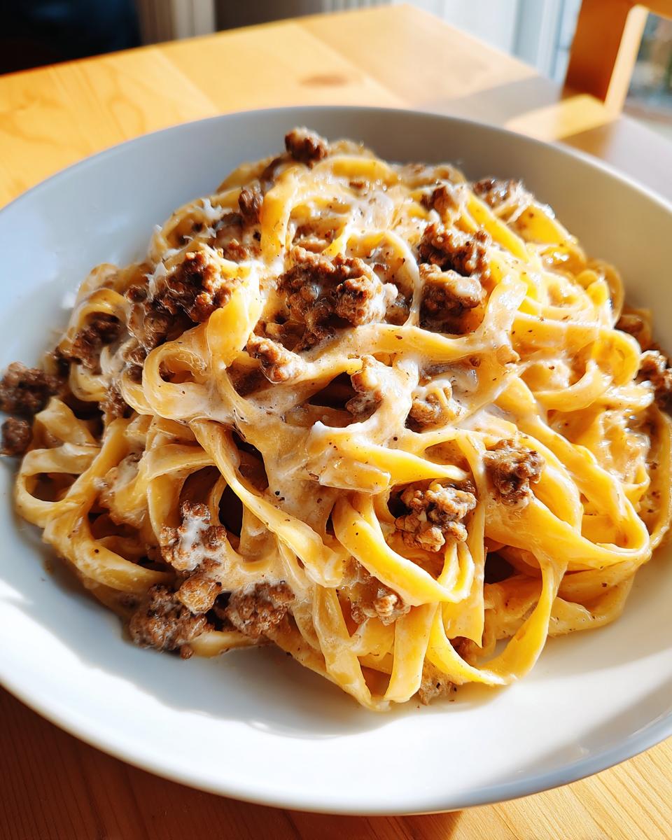 A close-up of creamy fettuccine noodles mixed with ground beef in a rich sauce, representing Garlic Parmesan Beef Pasta.