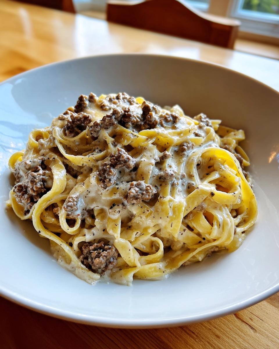 Close-up of rich Garlic Parmesan Beef Pasta featuring fettuccine coated in a creamy sauce with ground beef.