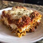 A hearty slice of Bowtie Pasta Lasagna layered with meat sauce, ricotta, and melted mozzarella cheese.