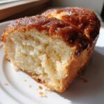 A close-up view of a slice of incredibly soft Sweet Hawaiian Bread with a shiny, caramelized brown sugar topping.