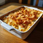 A baked Cream Of Chicken Recipes casserole topped with golden, crunchy cornflakes in a white dish.