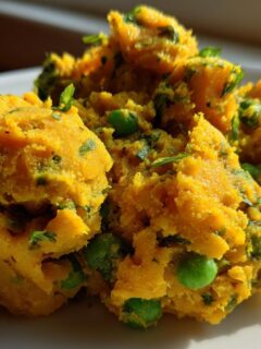 Close-up of bright yellow mashed potato and pea mixture, a popular Samosa Filling Ideas.