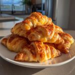 A golden pile of cheesy, flaky croissants ready to serve as one of the Iowa Party Bites.