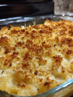 Close-up of a creamy Chicken Noodle Casserole baked in a glass dish with a golden, crispy breadcrumb topping.
