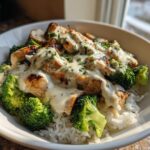 Close-up of Grilled Chicken Broccoli Bowls With Creamy Garlic Sauce served over white rice in a white bowl.