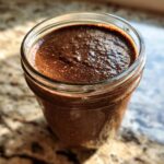 Close-up of thick, rich Creamy Chocolate Protein Overnight Oats in a glass jar.