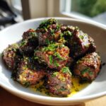 Close-up of seared Garlic Butter Beef Bites glistening with sauce and topped with fresh parsley.