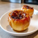 Close-up of a baked apple filled with a caramelized honey cinnamon dessert topping.